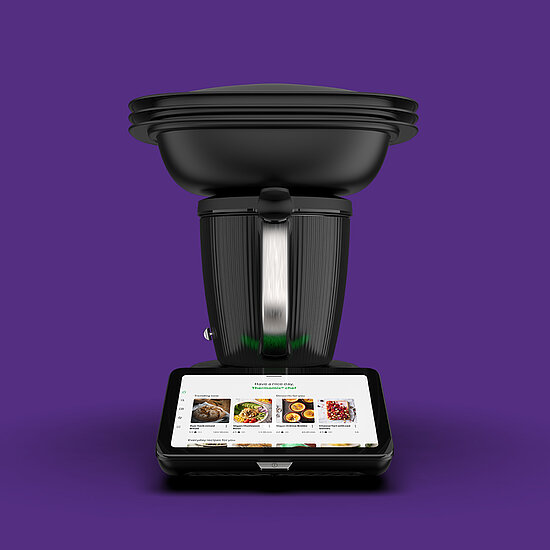 Vorwerk: Photo: The black TM7 from the front, against a purple background.
